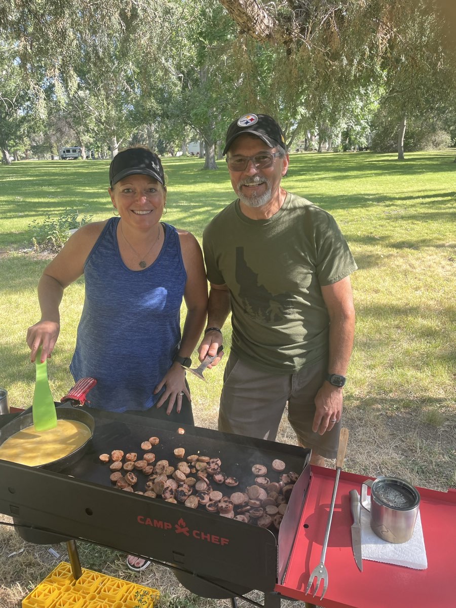 Gina and her husband having a BBQ on a camping trip