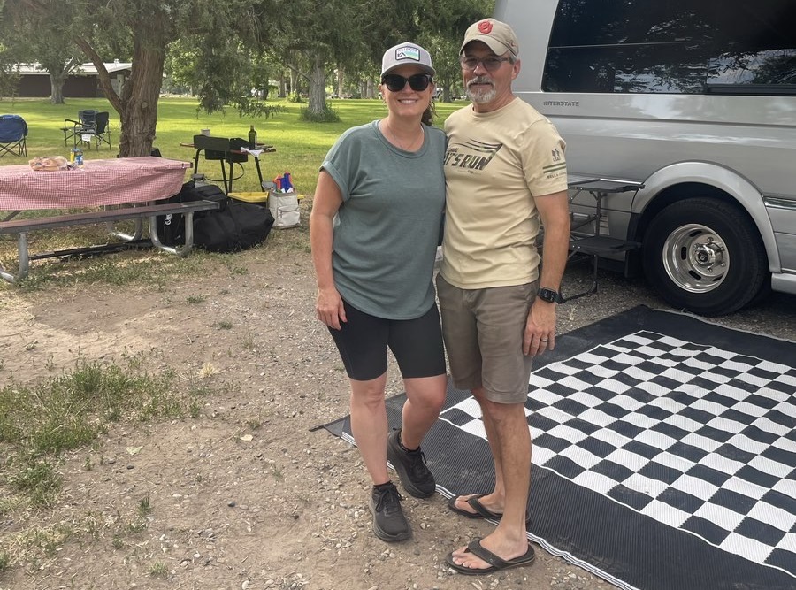 Gina and her husband in front of their camper van