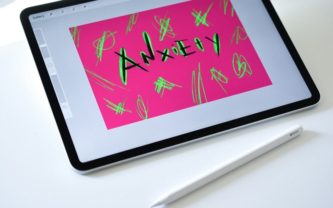 The word anxiety drawn on a tablet with the stylus resting next to it.