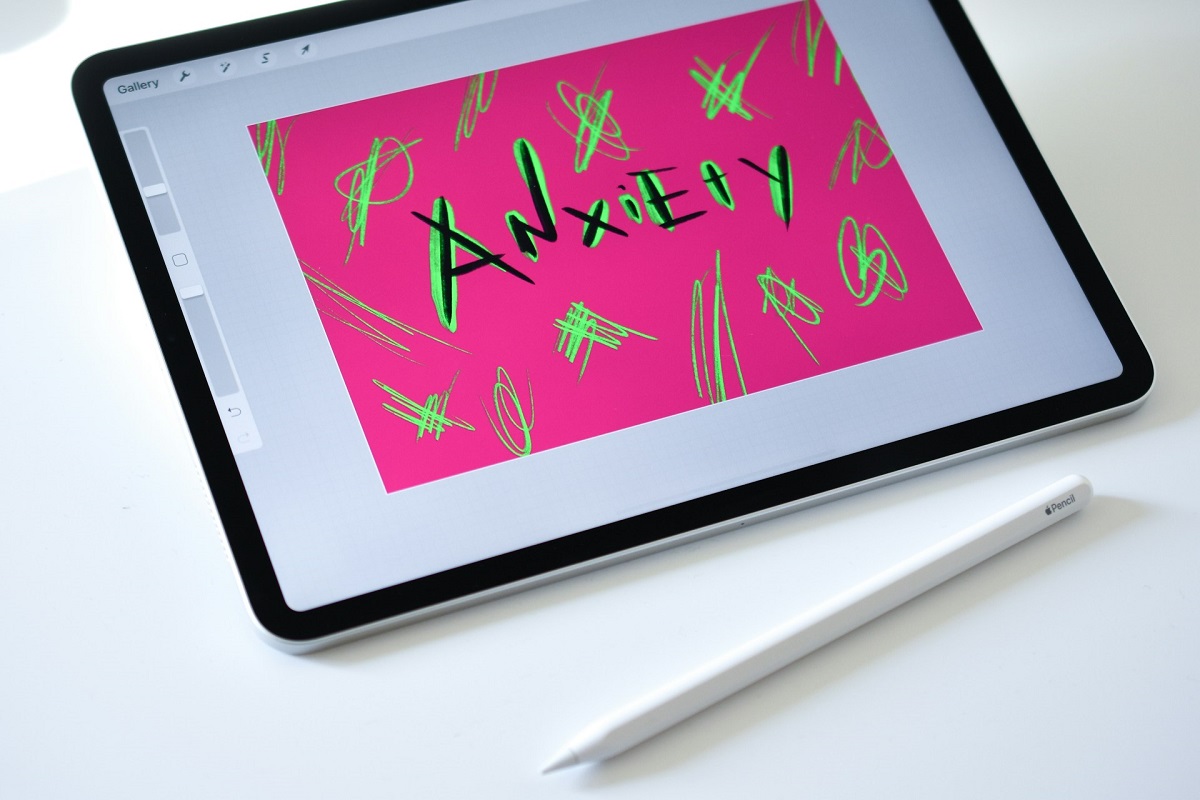 The word anxiety drawn on a tablet with the stylus resting next to it.