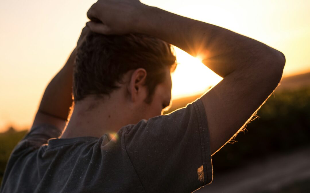 man with hands on top of head looking defeated