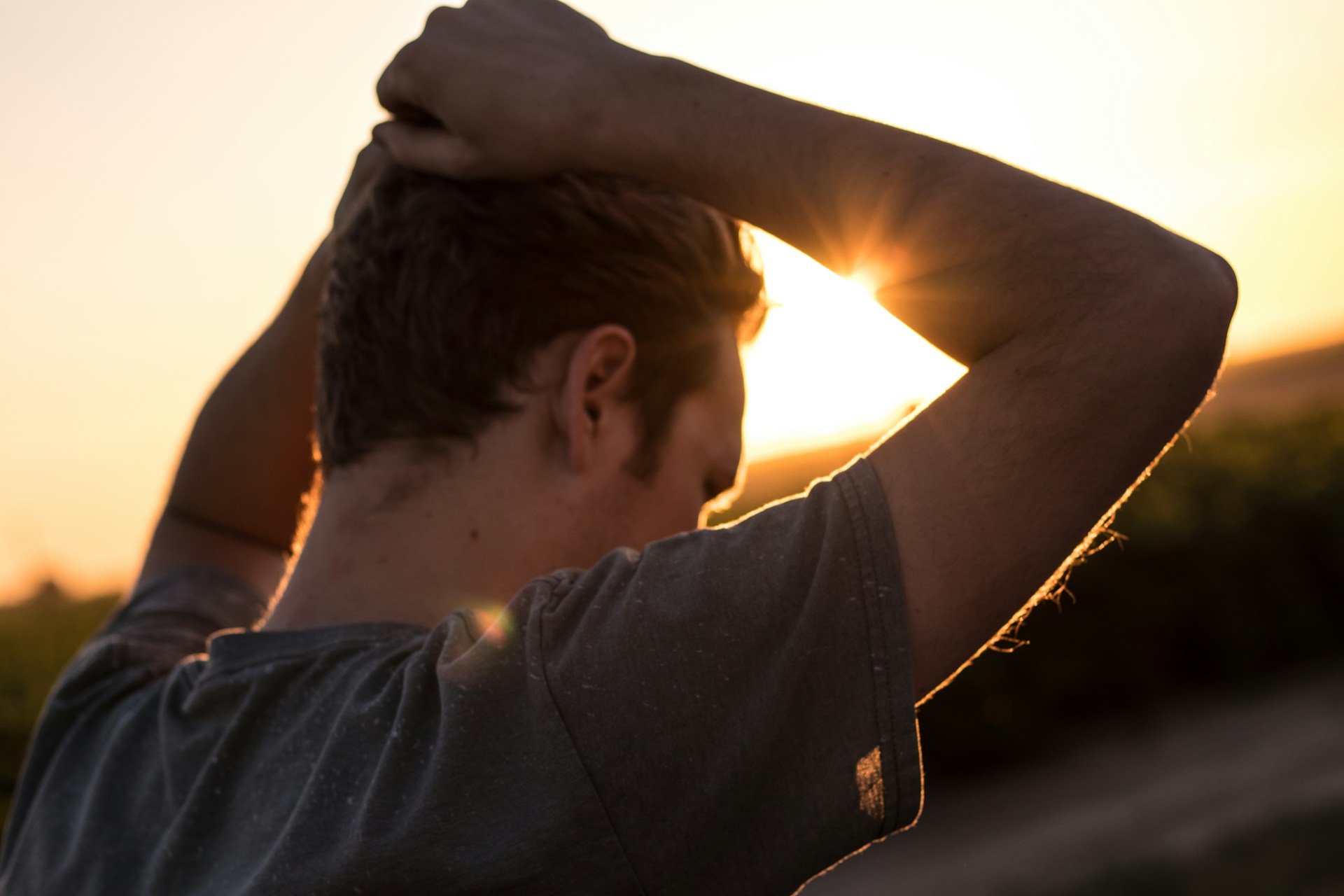 man with hands on top of head looking defeated