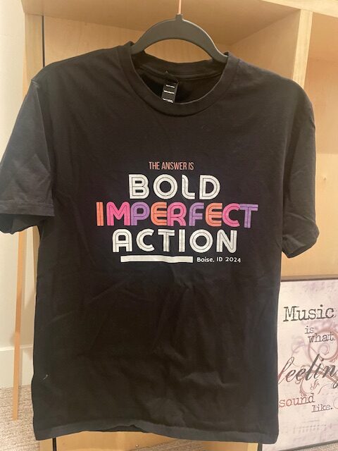 T Shirt with Bold Imperfect Action written on it